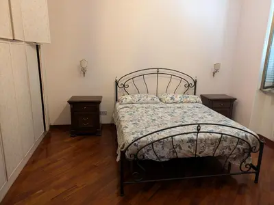 a bedroom with a bed and two night stands at Torpigna house in Rome