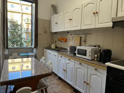 a kitchen with white cabinets and a microwave on a counter at Domus Urbani in Rome