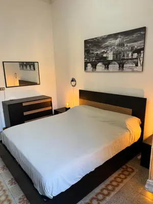 a bedroom with a large bed in a room at Domus Urbani in Rome
