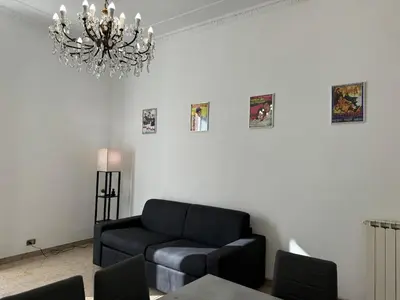 a living room with a couch and a chandelier at Domus Urbani in Rome