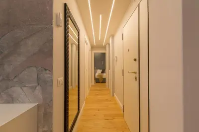 a hallway with white walls and wood floors at INTERNO 10 - Musei Vaticani in Rome