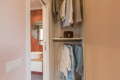 a walk in closet with towels and a mirror at INTERNO 10 - Musei Vaticani in Rome