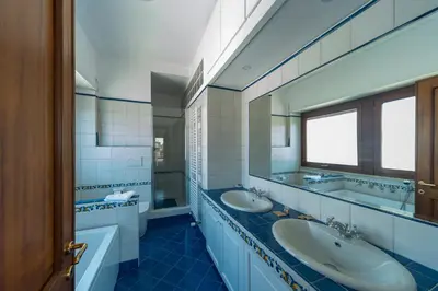 a bathroom with two sinks and a window at Cardinal Mistrangelo - next to the metro station, large and comfortable penthouse with terrace in Rome