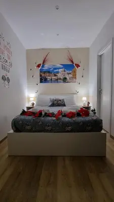a bedroom with a large bed with birds on the wall at Simone's apartment in Rome