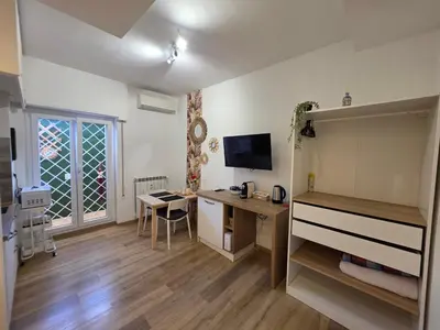 a room with a desk and a computer in it at Simone's apartment in Rome