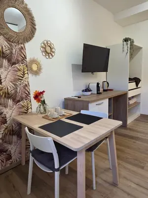 a room with a table and a desk with a television at Simone's apartment in Rome