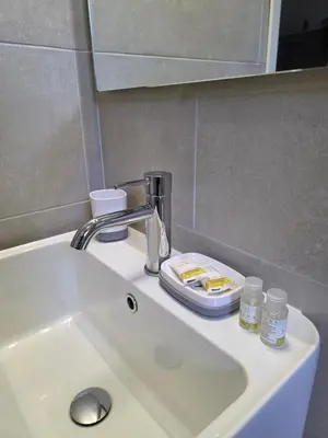 a sink in a bathroom with a faucet at Simone's apartment in Rome