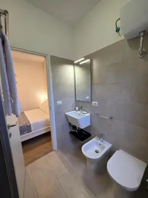 a bathroom with a sink and a toilet and a mirror at Simone's apartment in Rome