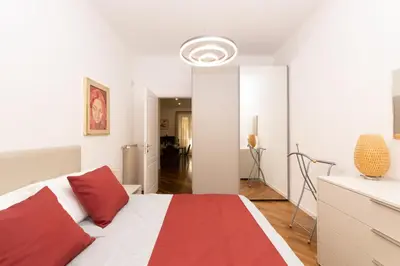 a bedroom with a bed with a red and white at Barca House in Rome