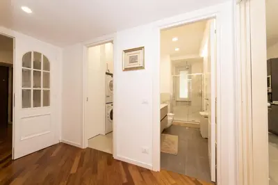 a hallway with white walls and a walk in closet at Barca House in Rome