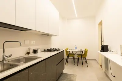 a kitchen with a sink and a table with chairs at Barca House in Rome