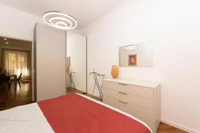 a bedroom with a bed and a dresser at Barca House in Rome