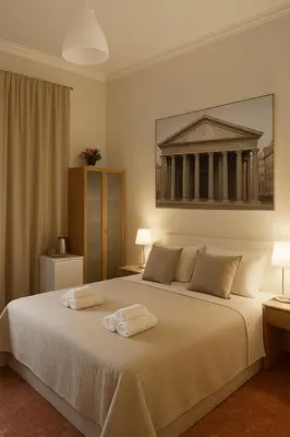 a bedroom with a large bed with two towels on it at Colosseo Rooms Rome in Rome