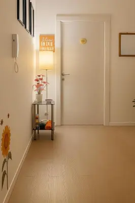a hallway with a door and a table with a lamp at Colosseo Rooms Rome in Rome