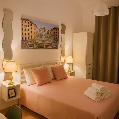 a bedroom with a bed with towels on it at Colosseo Rooms Rome in Rome