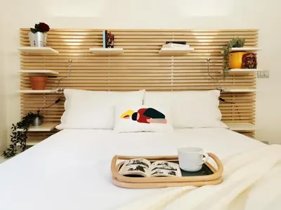 a tray with a book and a cup on a bed at Appiano Vatican city, lovely apartment, 2 room ,Wi-fi 250 mbps in Rome