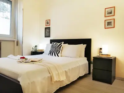 a bedroom with a large bed and a window at Appiano Vatican city, lovely apartment, 2 room ,Wi-fi 250 mbps in Rome