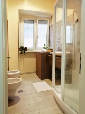 a bathroom with a toilet and a sink and a shower at Appiano Vatican city, lovely apartment, 2 room ,Wi-fi 250 mbps in Rome