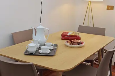 a table with a vase and a plate of food on it at 4BNB - Vittorio Emanuele Apartment in Rome