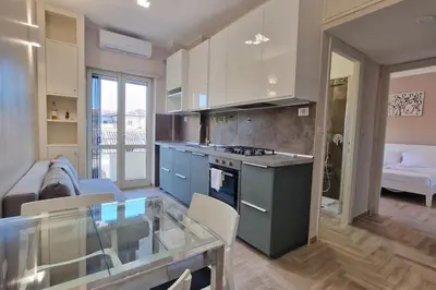 a kitchen and living room with a glass table at Vatican 6th floor Suite AC Panoramic views in Rome