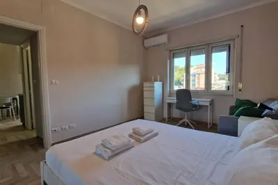 a bedroom with a bed with two towels on it at Vatican 6th floor Suite AC Panoramic views in Rome