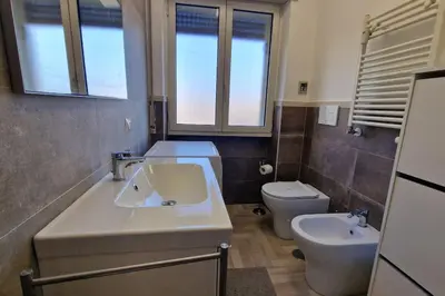 a bathroom with a sink and a toilet at Vatican 6th floor Suite AC Panoramic views in Rome