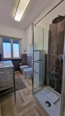 a bathroom with a shower and a sink and a toilet at Vatican 6th floor Suite AC Panoramic views in Rome