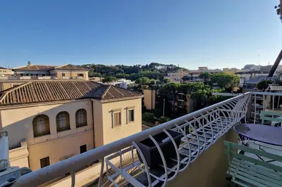 a balcony with chairs and a view of a city at Vatican 6th floor Suite AC Panoramic views in Rome