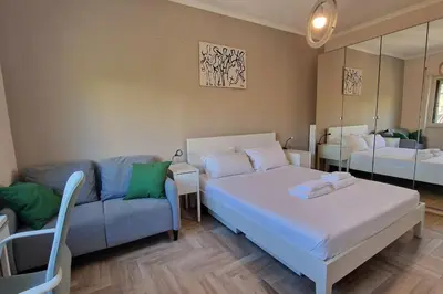 a living room with a bed and a couch at Vatican 6th floor Suite AC Panoramic views in Rome