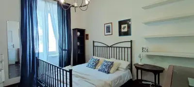 a bedroom with a bed and a table and a window at Trasteverino in Rome