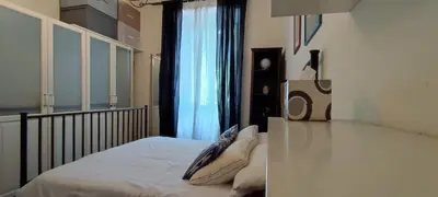 a bedroom with a bed with white sheets and a window at Trasteverino in Rome