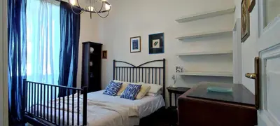 a bedroom with a bed and a desk and shelves at Trasteverino in Rome