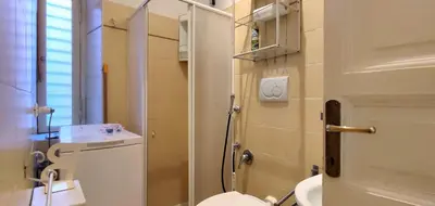 a small bathroom with a toilet and a sink at Trasteverino in Rome