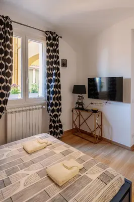 a bedroom with a bed with two towels on it at Roma Centro Holiday House in Rome
