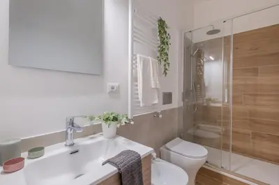 a bathroom with a sink and a toilet and a shower at Roma Centro Holiday House in Rome