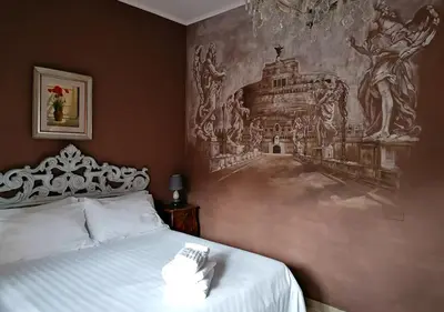 a bedroom with a bed with a painting on the wall at Gregory Place in Rome