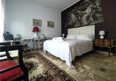 a bedroom with a bed and a painting on the wall at Gregory Place in Rome