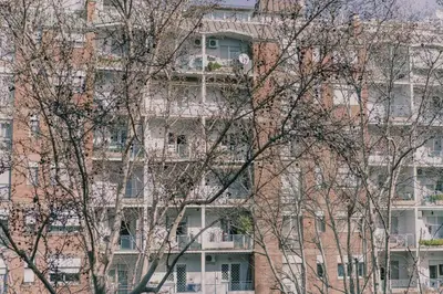 a tall brick building with trees in front of it at AMA Roma 5 minuti dal Colosseo in Rome