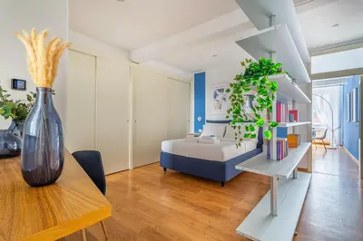 a bedroom with a bed and a table with a vase at iFlat Discovering Monti - Charming and Modern apt in Rome