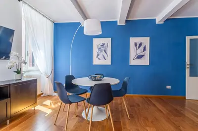 a dining room with blue walls and a table and chairs at iFlat Discovering Monti - Charming and Modern apt in Rome