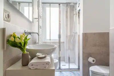 a bathroom with a sink and a shower at iFlat Discovering Monti - Charming and Modern apt in Rome