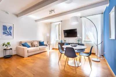 a living room with a couch and a table and chairs at iFlat Discovering Monti - Charming and Modern apt in Rome