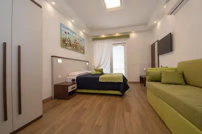 a small bedroom with a bed and a couch at rainbow al colosseo in Rome