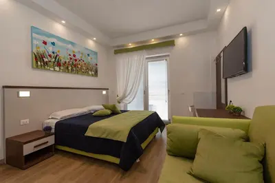 a bedroom with a bed and a couch at rainbow al colosseo in Rome