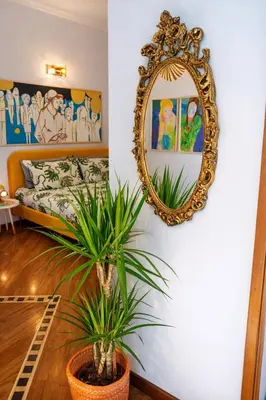 a mirror on a wall next to a bedroom at Testaccio Artistic Home - Centro Storico Roma - RIONI DI ROMA in Rome