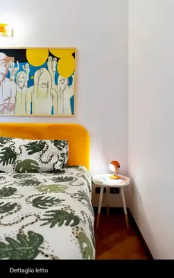 a bedroom with a bed and a side table at Testaccio Artistic Home - Centro Storico Roma - RIONI DI ROMA in Rome