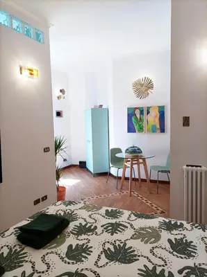 a room with a bed and a table and chairs at Testaccio Artistic Home - Centro Storico Roma - RIONI DI ROMA in Rome