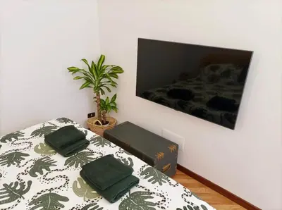 a bedroom with a bed with two green pillows on it at Testaccio Artistic Home - Centro Storico Roma - RIONI DI ROMA in Rome