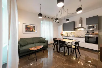 a living room with a green couch and a table at Roomeasy Vatican Apartment in Rome