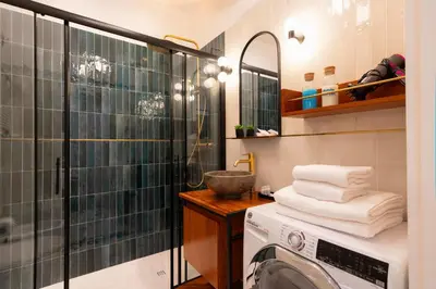 a washing machine in a bathroom with a shower at Roomeasy Vatican Apartment in Rome
